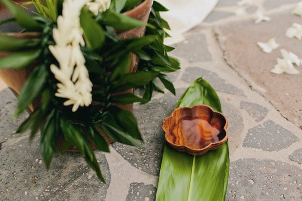 Hawaii wedding ring exchange with leafy lei during an intimate elopement